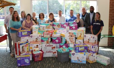 Quarles staff and the thousands of diapers and wipes gathered during their baby drive