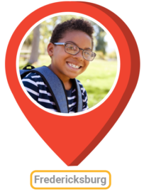 map pin icon with image of boy with backpack and the word Fredericksburg