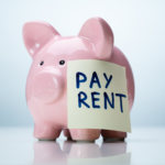 piggy bank with Pay Rent note