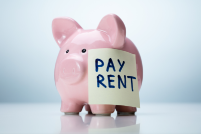 piggy bank with Pay Rent note